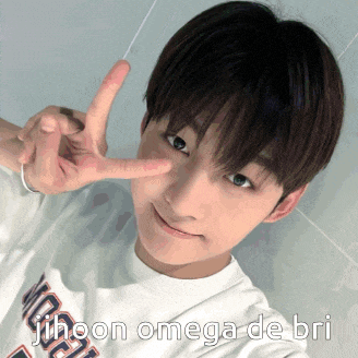 a young man is making a peace sign with his fingers