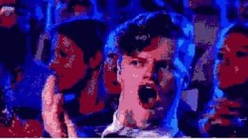 a pixelated image of a man with his mouth open and a woman behind him