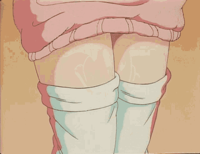 a woman in a pink sweater is holding her stomach