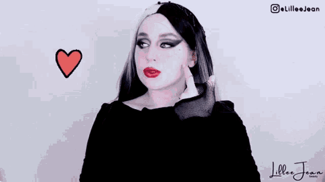 a woman is wearing a black and white wig and has a broken heart on her face .