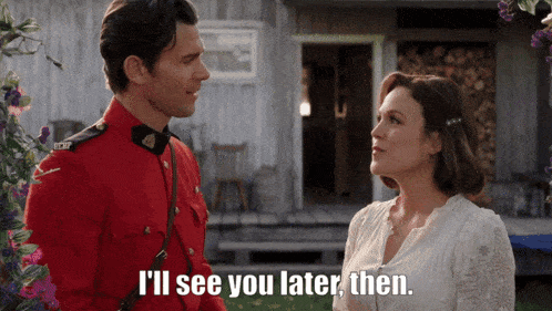 a man in a red uniform is talking to a woman in a white dress