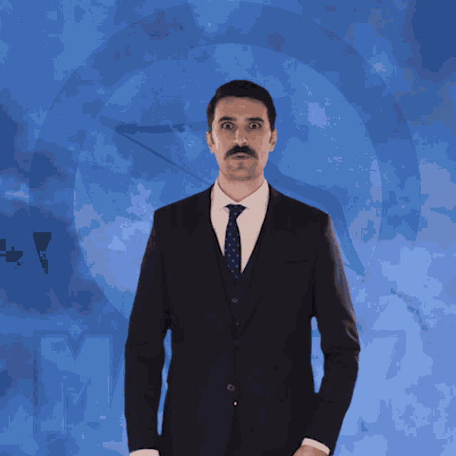 a man in a suit and tie is making a funny face