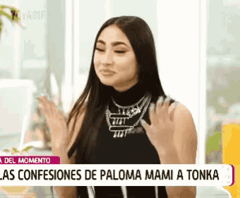 a woman in a black top is being interviewed by a news channel