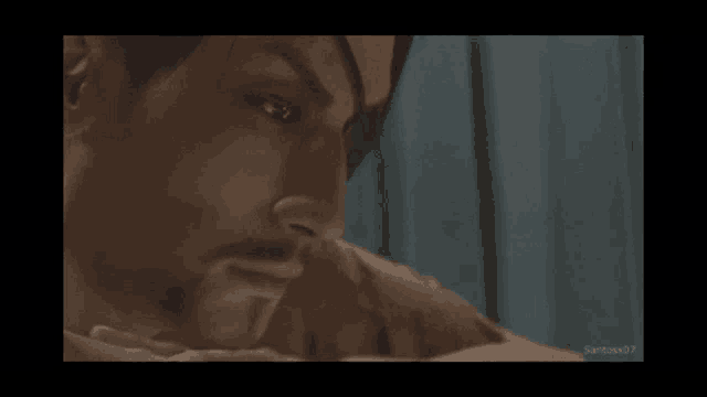 a close up of a man 's face with a beard looking at something .