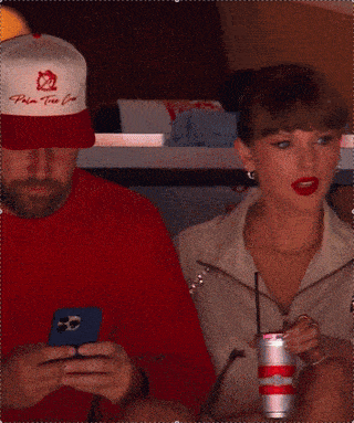 a woman wearing red lipstick is sitting next to a man wearing a pink shirt