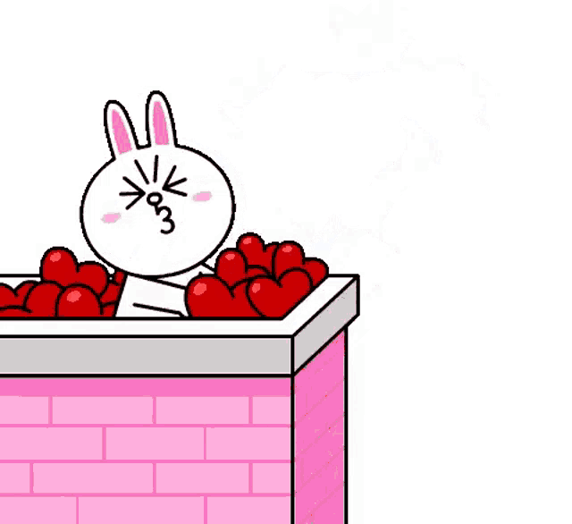 a cartoon rabbit is sitting in a box of hearts .