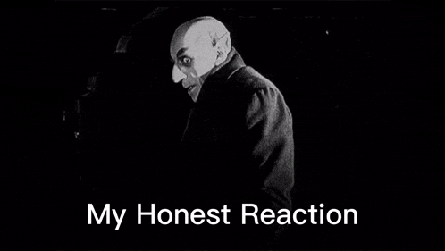 a black and white photo of a vampire with the words `` my honest reaction '' written above him .