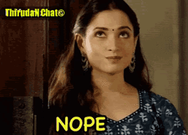 a woman is making a funny face and the word nope is on the screen behind her