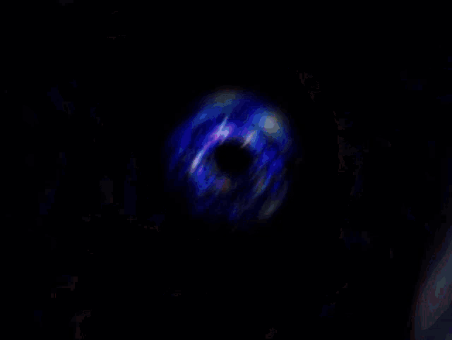 a colorful swirl with a black hole in the center