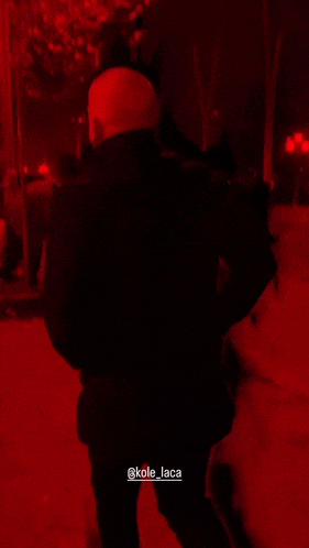 a silhouette of a person in a red light with the name kole_laca on the bottom right