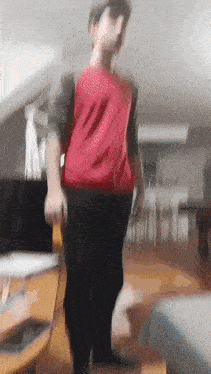 a blurry picture of a person in a red shirt