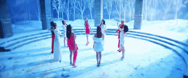 a group of women are standing in a snowy area