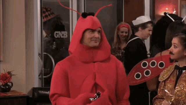 a man in a lobster costume stands in front of a gnb store