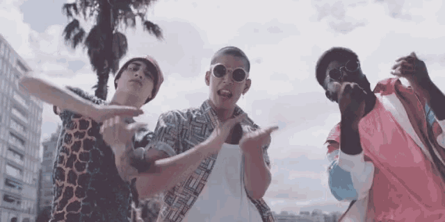 a group of young men are dancing in a video