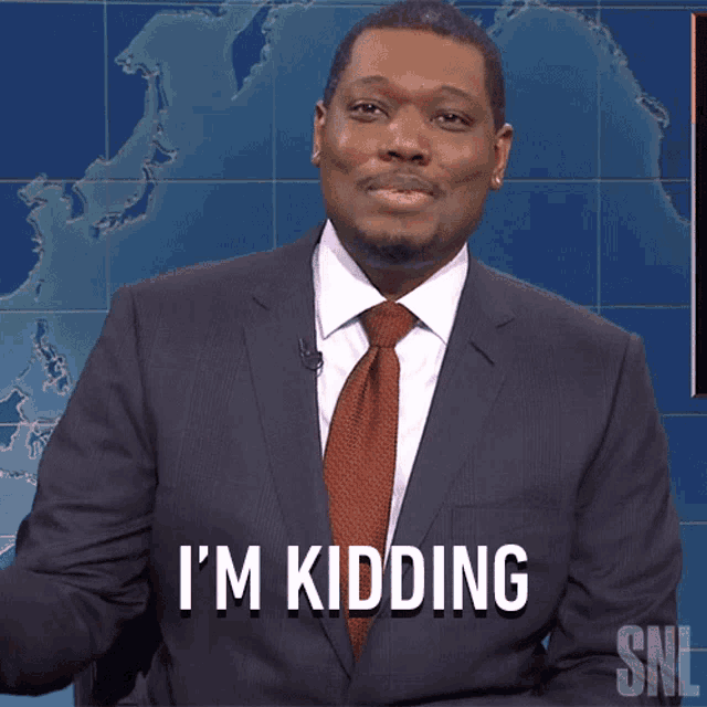 a man in a suit and tie says i 'm kidding on snl
