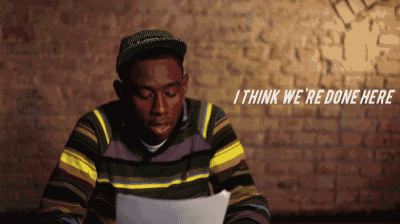 a man in a striped sweater is looking at a piece of paper with the words i think we 're done here above him