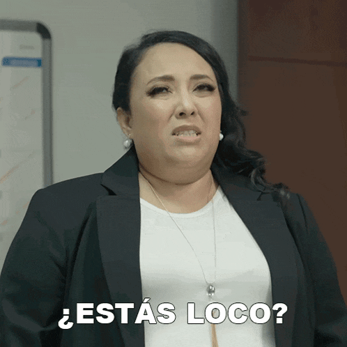 a woman in a black jacket and white shirt is asking " estas loco "