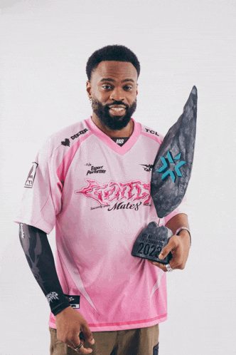 a man wearing a pink shirt that says mates