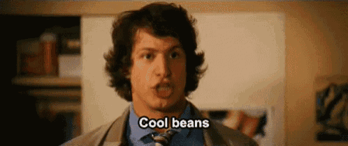 a man in a suit and tie is making a funny face and saying `` cool beans '' .