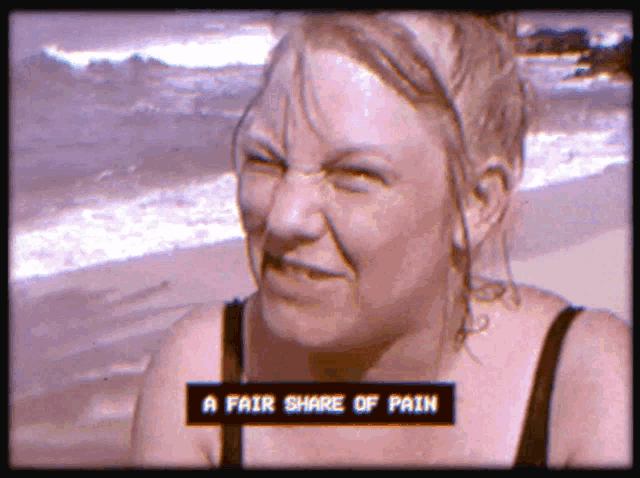 a woman on a beach with the words a fair share of pain on the screen