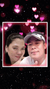 a man and a woman are posing for a picture with pink hearts surrounding them