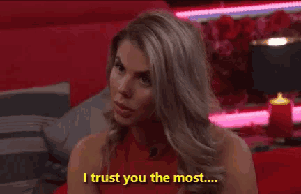 a woman says i trust you the most while sitting on a red couch