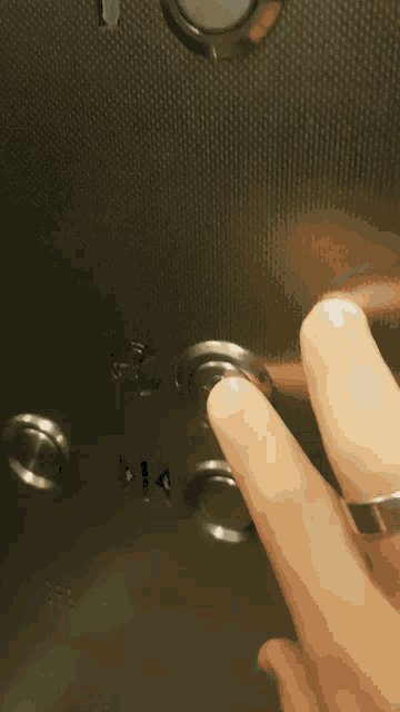 a person pressing a button in an elevator