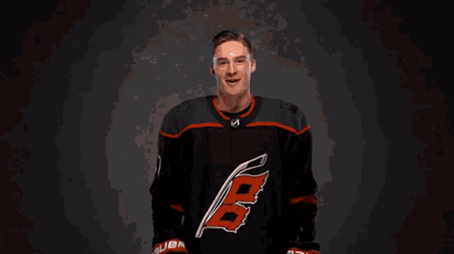 a hockey player wearing a jersey with the number 5 on it