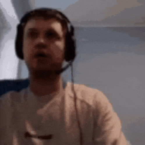 a man wearing headphones and a microphone is sitting on a plane .