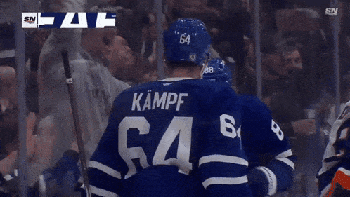 two hockey players are celebrating a goal with the sn logo in the background