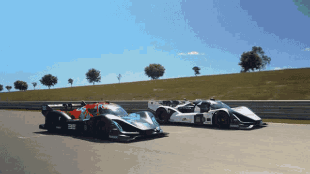 two race cars are on a track and one has the letters ee on the front