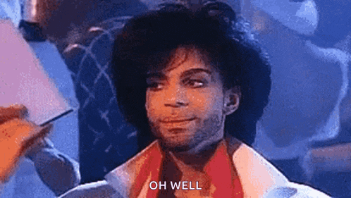 prince is wearing a hat and a scarf and says `` oh well '' while looking at the camera .