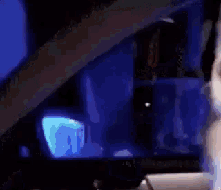 a blurry image of a person 's face with a blue background