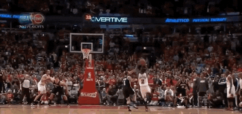 a basketball game is being played in front of a crowd and the scoreboard says 38 overtime