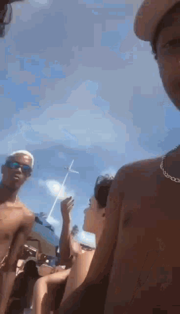 a group of young men are standing on a beach .