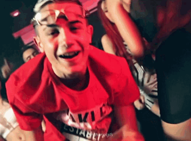 a young man wearing a red shirt that says ' stable ' on it