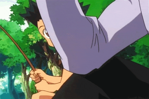 a person holding a fishing rod in a forest