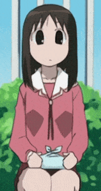 a girl in a pink shirt is sitting on a bench holding a blue box .