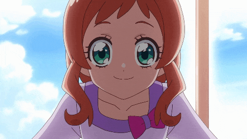 a cartoon girl with red hair and green eyes is smiling