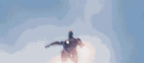 iron man is flying through the air in a blurry photo .
