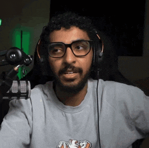 a man with a beard wearing headphones and glasses