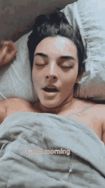 a woman laying in bed with her eyes closed and the words " good morning " written on the bottom