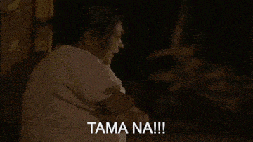 a woman in a white shirt says tama na !!! in a dark room