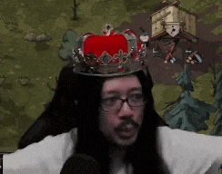 a man with long hair and glasses wearing a crown on his head