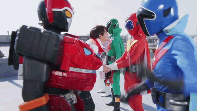 a group of superheros are shaking hands with each other on a rooftop