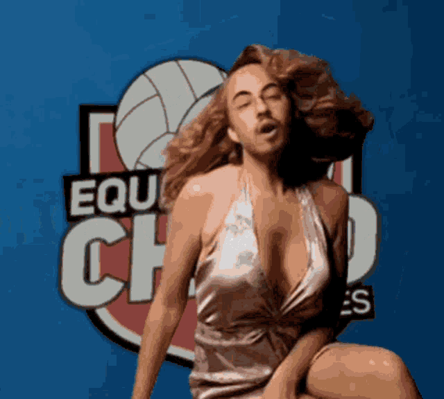 a woman is sitting in front of a sign that says equachado