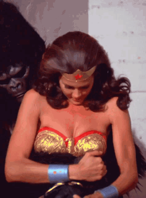 a woman in a wonder woman costume holds her breast