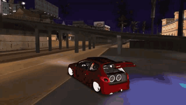 a black car is driving under a bridge with a white van in the background