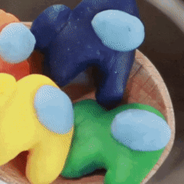 among us cupcakes in a wooden bowl with a yellow among us and a blue among us