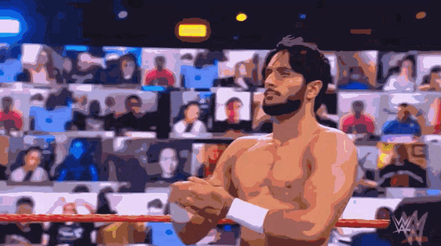 a man in a wrestling ring with a w logo